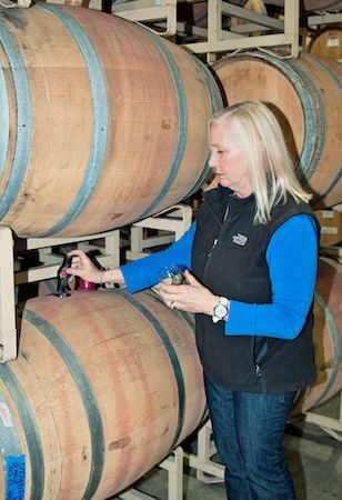 Woman serving wine directly from wine cask